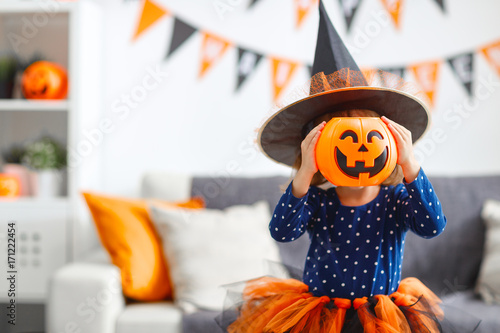 happy   child girl in witch costume to halloween