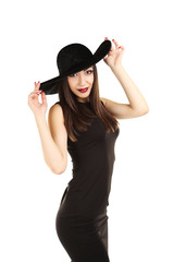 Young brunette woman in black dress on a white background