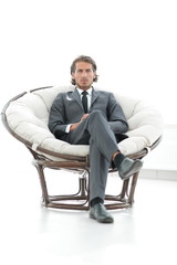 confident businessman sitting in a large comfortable chair.