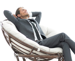 happy businessman relaxing in big comfortable armchair