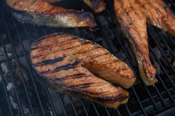 Salmon red fish steaks on the flaming grill