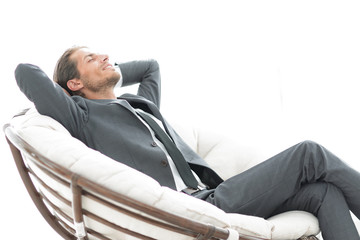 young businessman sitting in large comfortable armchair.