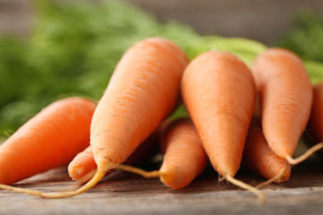 Fresh and ripe carrots on wooden table