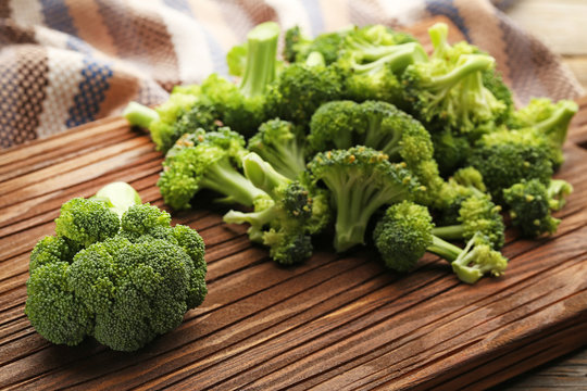 Fresh broccoli on brown cutting board