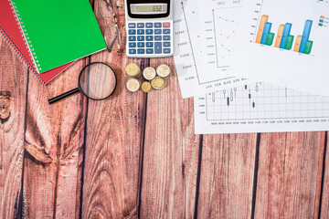 Business concept - diagram, stock graph, pen and calculator on desk.