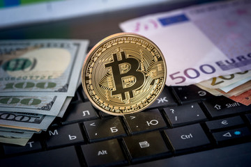 dollar, euro, bitcoin and laptop, close up