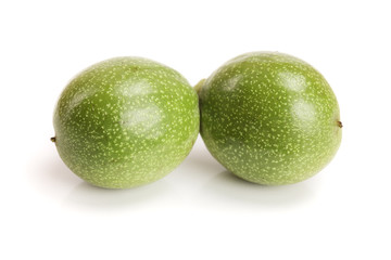 fresh walnuts in peel isolated on white background