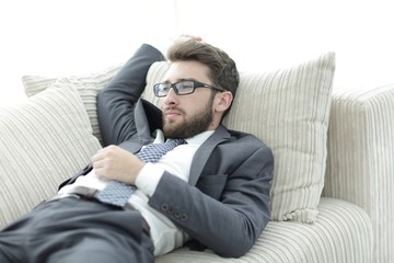 Obraz premium tired businesswoman relaxing on the couch.