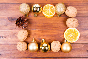 Walnuts. orange and christmas balls on a wooden backgrounds