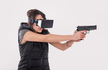 Woman play VR shooter game with vr glasses and gun