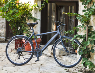 Fototapeta na wymiar Gray bicycle on the street. Old city. Nessebar