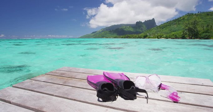 Vacation travel landscape background with snorkeling gear mask and fins ready for snorkel watersports on tropical holidays. RED EPIC SLOW MOTION.