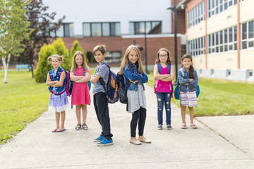 Great Portrait Of School Pupil Outside Classroom Carrying Bags