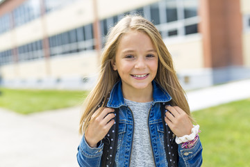 Great Portrait Of School Pupil Outside Classroom Carrying Bags