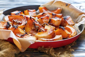 pieces of baked pumpkin on a sheet of parchment.