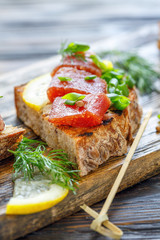 Homemade bread with cheese, herring caviar and chives.