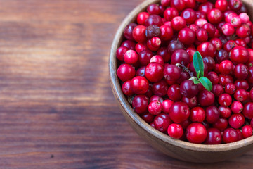 Cowberry, Grapeshot, Red Bilberry, Red Whortleberry,Mountain Cranberry,Lingonberry in bowl .Wooden...