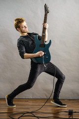 Fototapeta premium Young man playing electric guitar