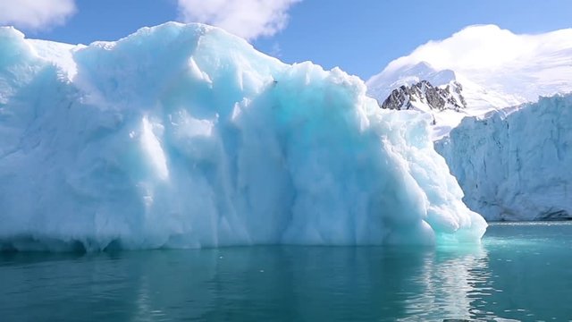 View of the glacier in the water against the shore. Andreev.