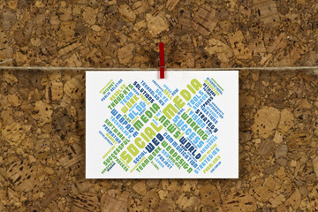 Social Media word cloud on business card pinned up on cork board