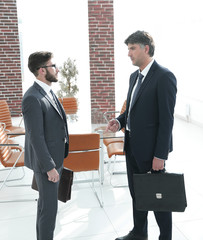boss and the employee of the company are talking in the office