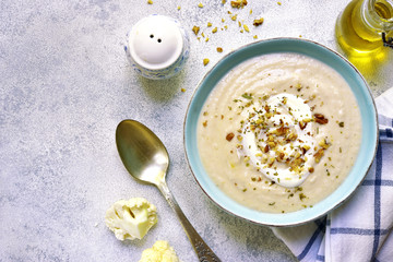 Creamy cauliflower soup with walnuts.Top view.