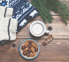 Christmas, winter decor and a mug of cocoa with nuts on a wooden background, holiday concept.