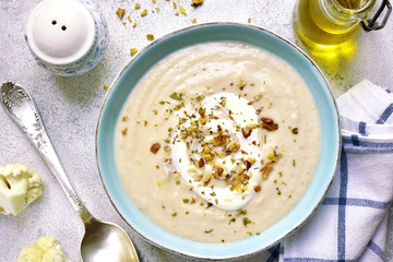 Creamy cauliflower soup with walnuts.Top view.