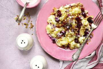 Autumn cauliflower salad with dried cranberry,walnut and red onion.Top view.
