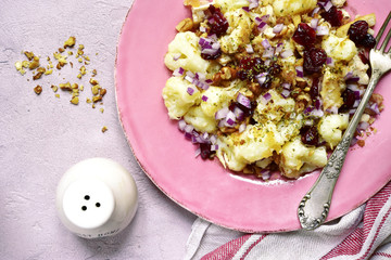 Autumn cauliflower salad with dried cranberry,walnut and red onion.Top view.