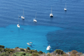 Ships anchored off the coast of Corsica on the blue calm sea, view from above