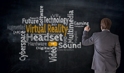 Businessman writes Virtual Reality Cloud on blackboard concept