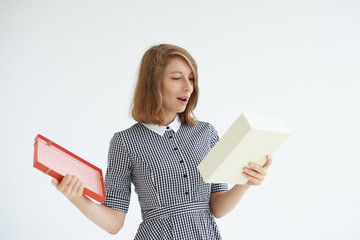 Picture of positive and emotional young woman wearing checkered dress feeling excited after she...