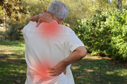 Senior Man Suffering Fron Back Pain. Pain Relief And Health Care Concept.