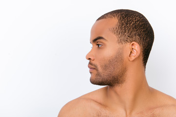 Fototapeta premium Hygiene, vitality, beauty, men life concept. Side profile view of afro young nude guy with stubble isolated on pure background, copy space near