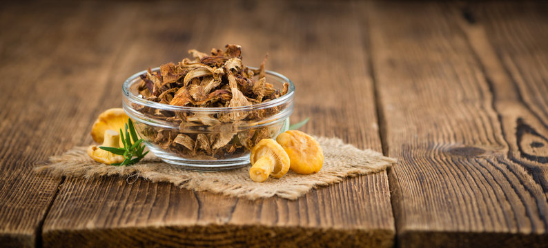 Wooden table with Dried Chanterelles, selective focus