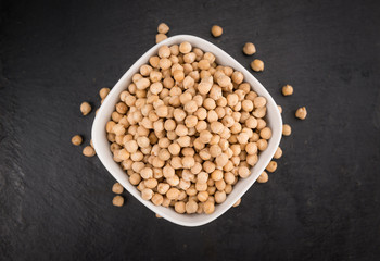 Chickpeas on a slate slab, selective focus