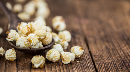 Popcorn on wooden background; selective focus