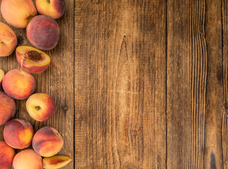 Portion of Fresh Peaches on wooden background, selective focus