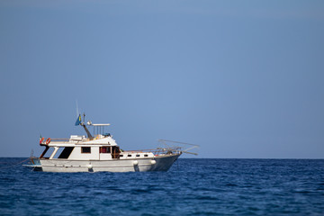 Fototapeta na wymiar Small fishing boat in the sea