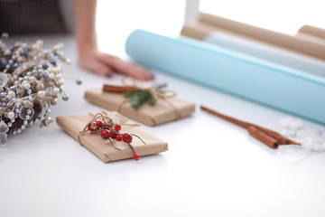 Hands of woman decorating christmas gift box