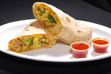 Breakfast Burrito with egg and potatoes inside and red sauce - obrazy, fototapety, plakaty
