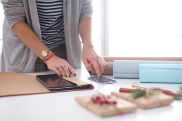 Hands of woman decorating christmas gift box