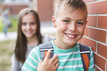 Portrait of two school friends with backpacks