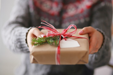 Hands of woman holding christmas gift box