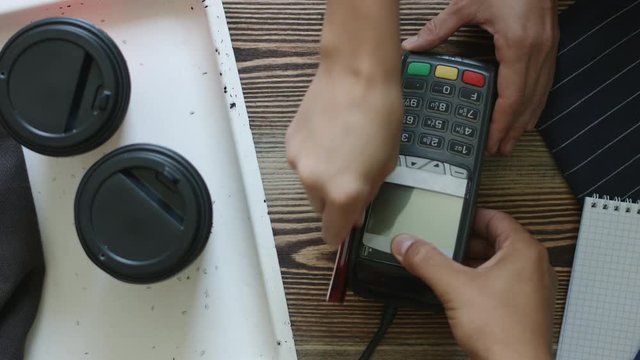 Close-up shot of person using credit card for mobile payment