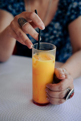 Close up on glass of fresh fruits drink over light table background. Healthy positive lifestyle