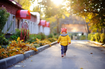 Happy little child running home after kindergarten