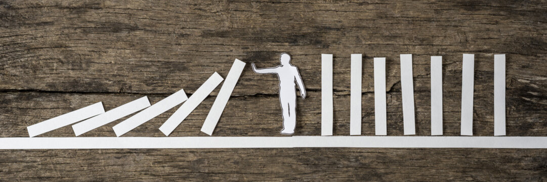 Man stopping the domino effect