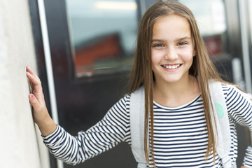 Elementary school pupil outside carrying rucksack